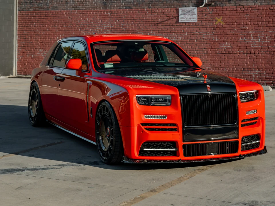 Red luxury sedan with a contrasting black hood and roof