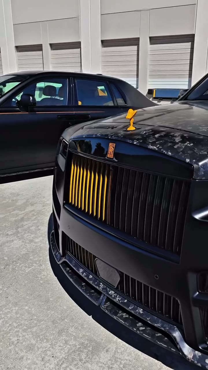 Black Rolls-Royce with a bright orange interior after its wrap